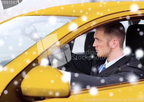 Image of close up of businessman driving car