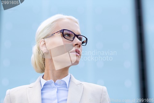 Image of young businesswoman over office building