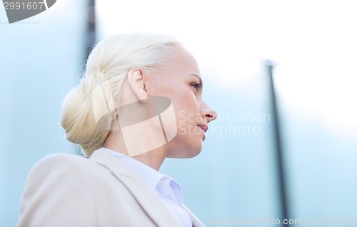 Image of young businesswoman over office building