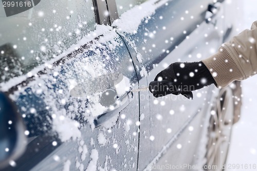 Image of close up of man with car key outdoors