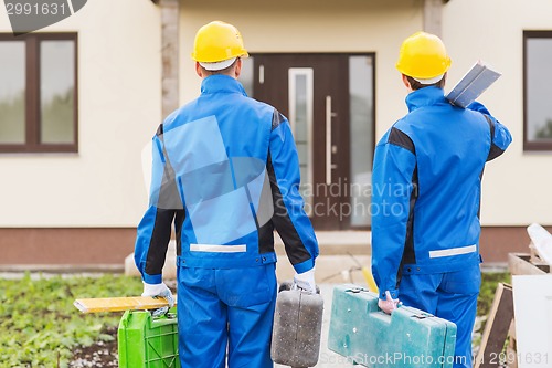 Image of group of builders with toolboxes