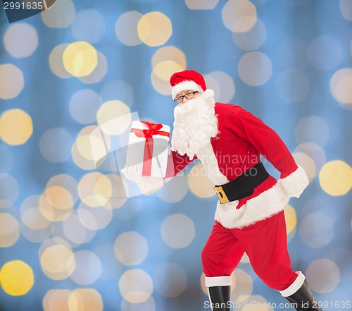 Image of man in costume of santa claus with gift box