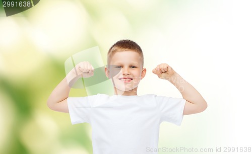 Image of happy little boy in white t-shirt flexing biceps