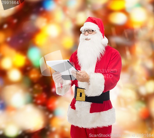 Image of man in costume of santa claus with notepad