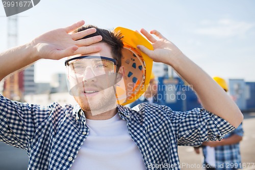 Image of group of builders in hardhats outdoors