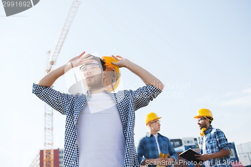 Image of group of builders in hardhats outdoors