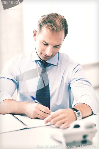 Image of handsome businessman working in the office