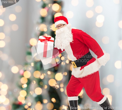 Image of man in costume of santa claus with gift box