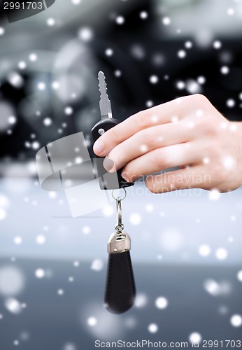 Image of close up of man with car key outdoors