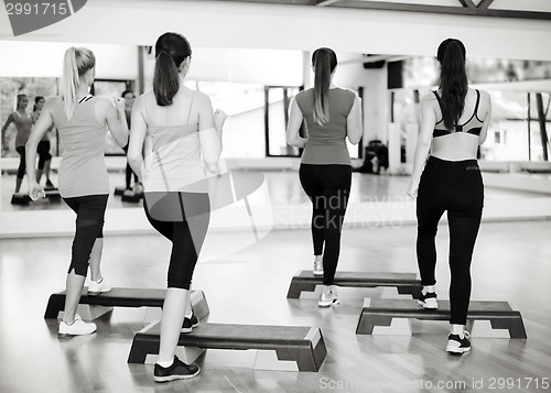 Image of group of smiling people doing aerobics