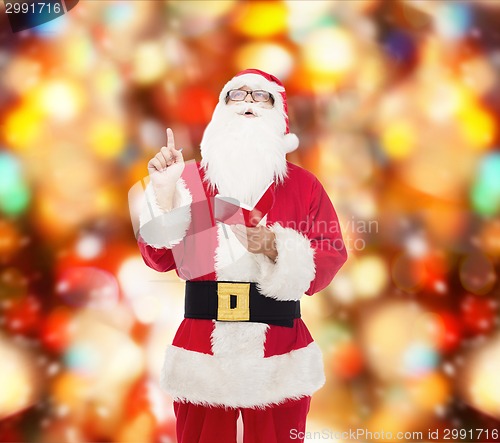 Image of man in costume of santa claus with notepad