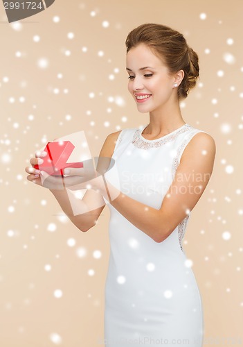 Image of smiling woman holding red gift box