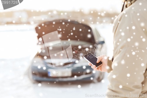 Image of closeup of man with broken car and smartphone