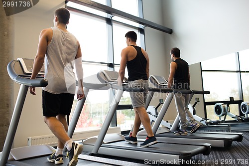 Image of men exercising on treadmill in gym