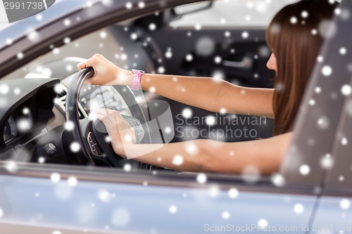 Image of close up of smiling businesswoman driving car