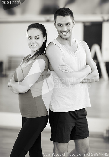 Image of two smiling people in the gym