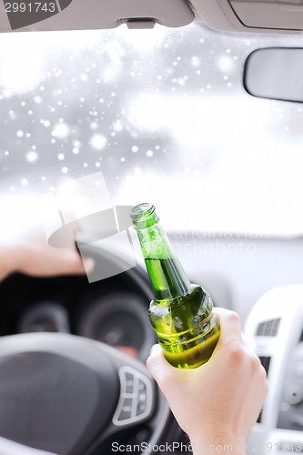 Image of close up of man drinking alcohol while driving car