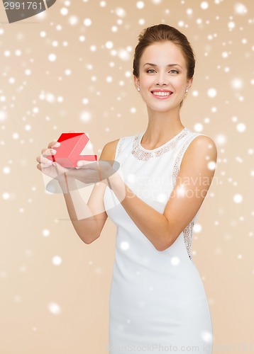 Image of smiling woman holding red gift box