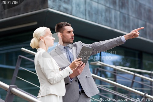 Image of serious businessmen with tablet pc outdoors