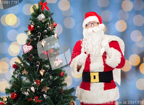 Image of santa claus with bag and christmas tree