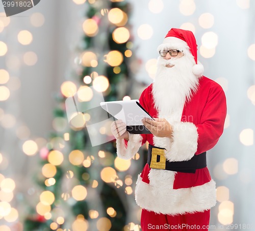 Image of man in costume of santa claus with notepad