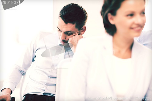 Image of tired businessmen sleeping on conference