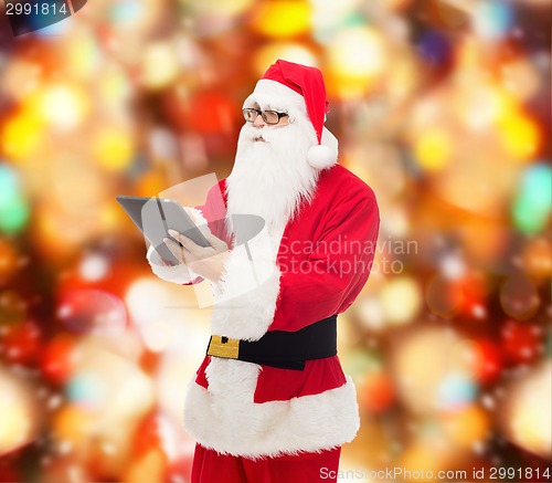 Image of man in costume of santa claus with tablet pc