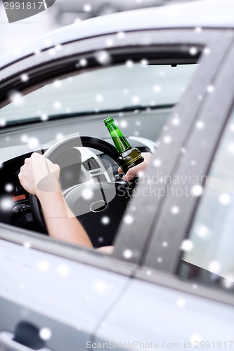 Image of close up of man drinking alcohol while driving car