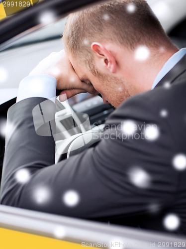 Image of close up of businessman driving car