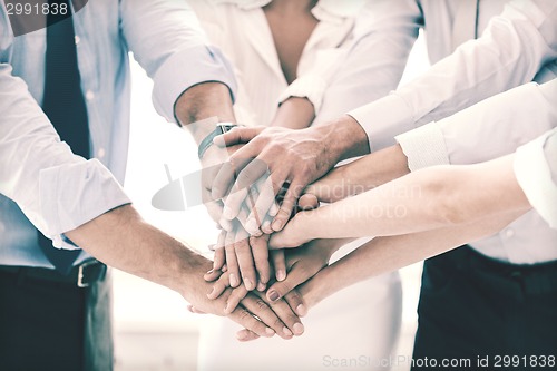 Image of business team celebrating victory in office