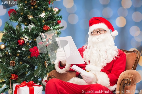 Image of man in costume of santa claus with letter