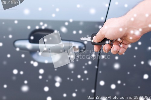 Image of close up of man with car key outdoors