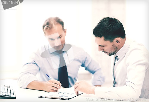 Image of businessmen with notebook on meeting