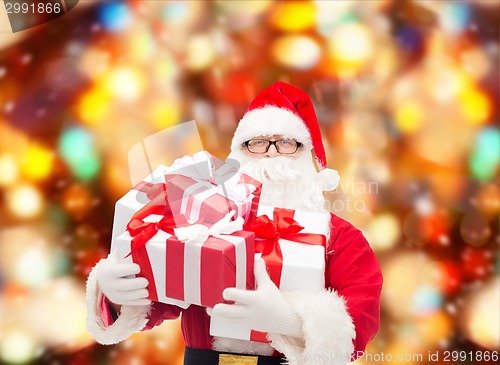 Image of man in costume of santa claus with gift boxes