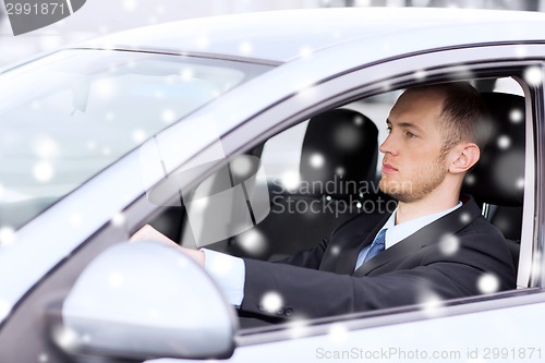 Image of close up of businessman driving car