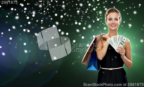 Image of smiling woman in dress with shopping bags