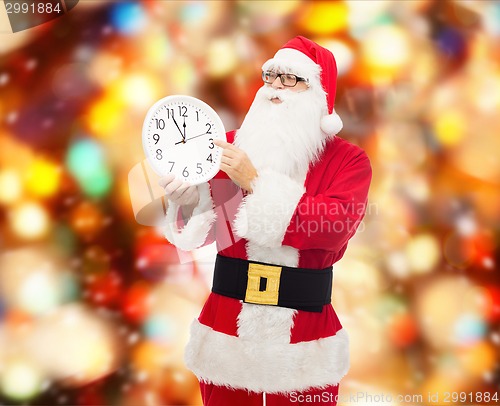 Image of man in costume of santa claus with clock