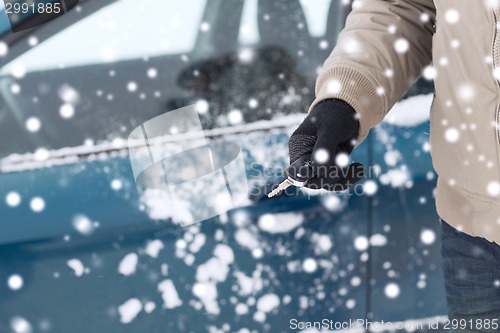 Image of close up of man with car key outdoors