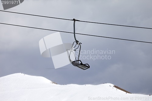 Image of Chair lift and off-piste slope at gray day