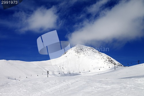 Image of Chair-lift and ski slope at sun wind day