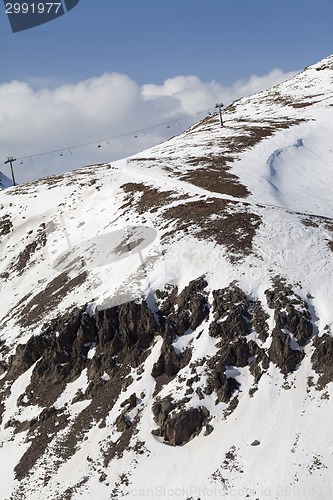 Image of Off-piste slope with stones and chair-lift in little snow year