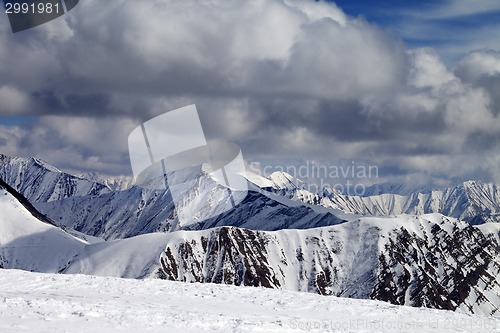 Image of Winter snowy mountains in clouds