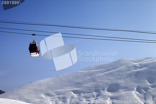 Image of Gondola lift and off-piste slope at sun morning