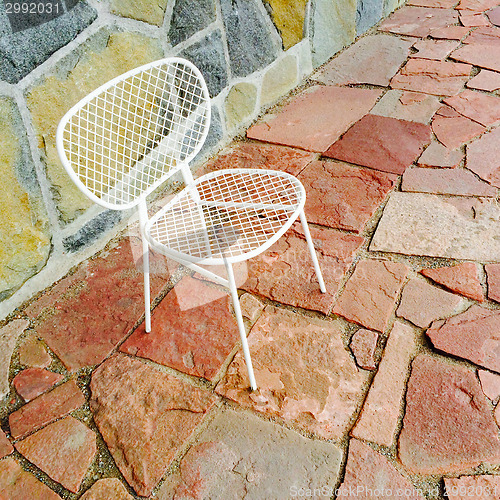 Image of White chair on bright tile background