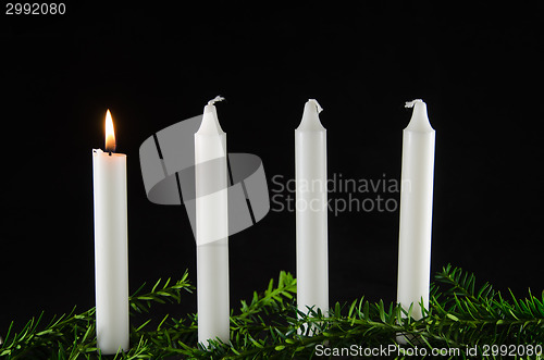 Image of Four advent candles at black background