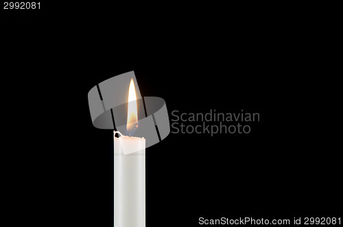 Image of A white burning candle