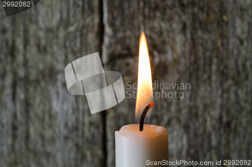 Image of A single burning candle