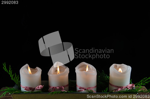 Image of Four decorated advent candles at black background