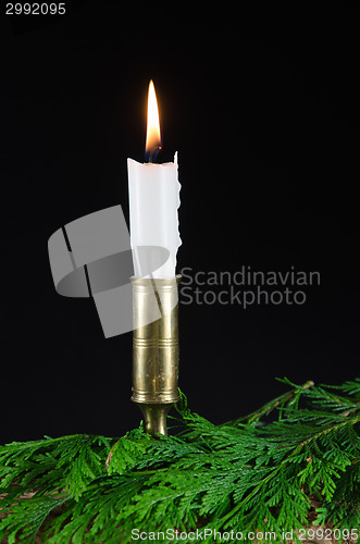 Image of One candle with green twigs