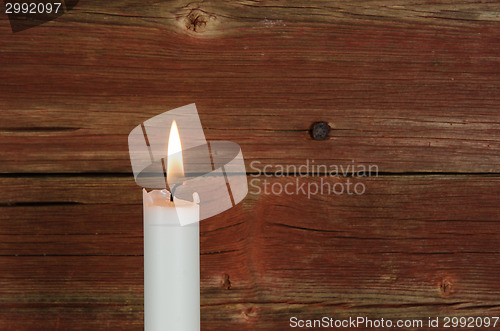 Image of Single candlelight at old wall